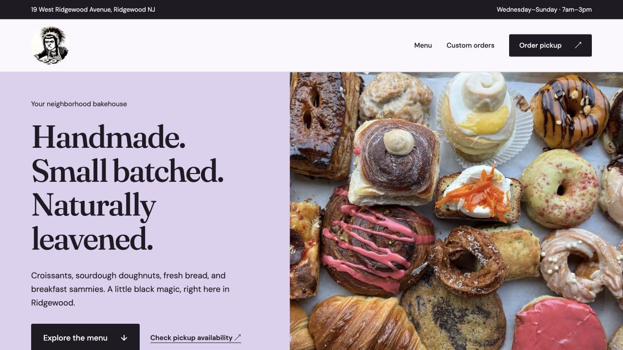 Black Magic Bakehouse concept with a lavender hero, large Handmade, Small batched, Naturally leavened headline, and a photograph of pastries.